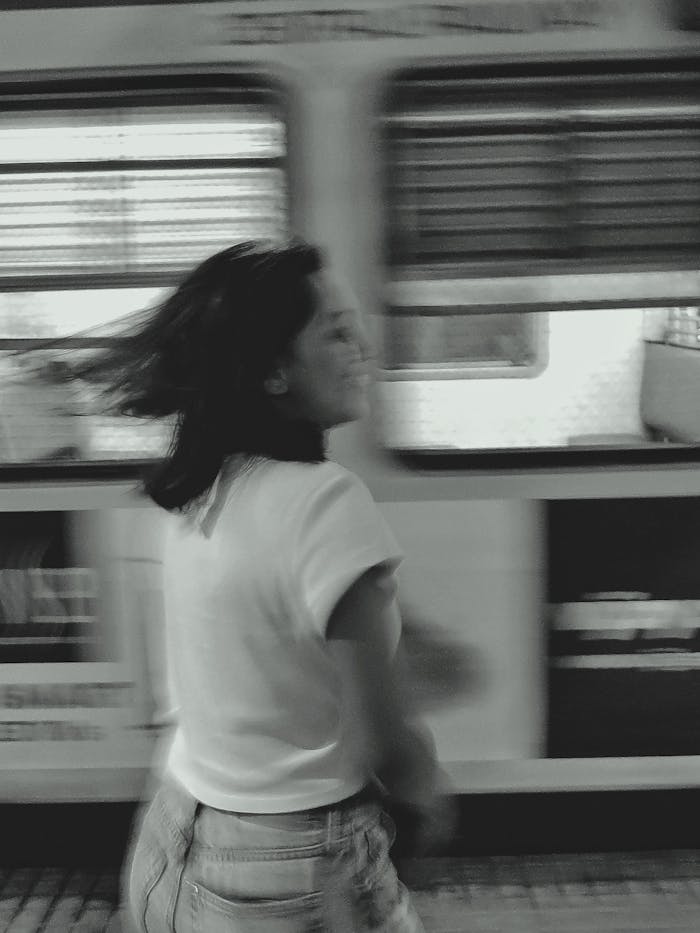 blurred girl and train passing behind in the background